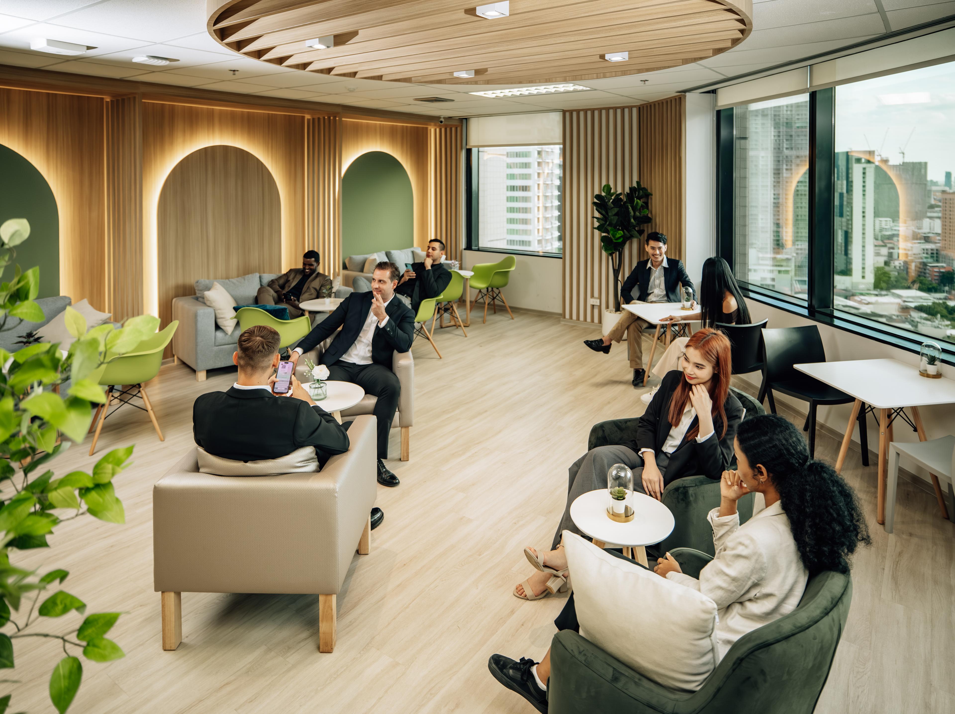 group of people sitting in lounge in green colors